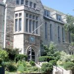 Image depicts the exterior of Brennan Hall on a sunny day