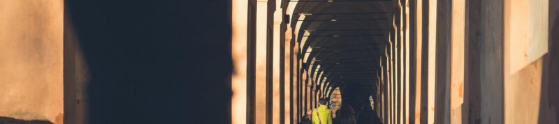 Image of students walking outside with building architecture