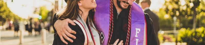 Image of two students embracing at commencement