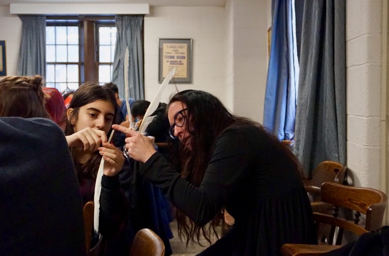 Assistant Professor Alison More helps a Boyle Seminar student to prepare a quill pen in the manner of mediaeval monks. 