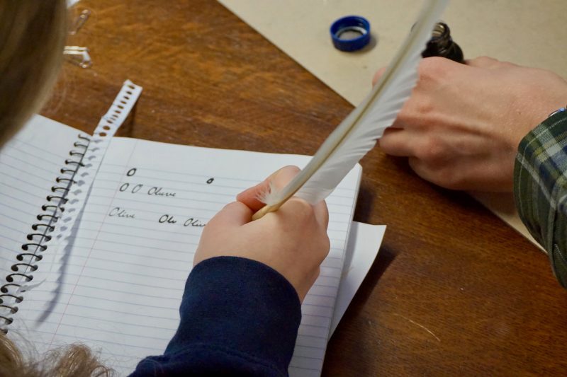 Image depicts a student practicing Caligraphy