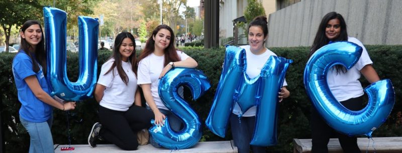 Image depicts a group of students holding USMC balloons