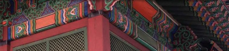 Image depicts the corner of a building with intricate art working