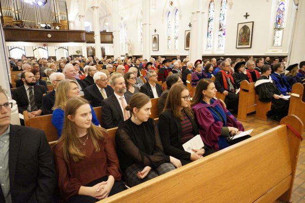 A large crowd fills the pews to the back of St. Basil's Church. 