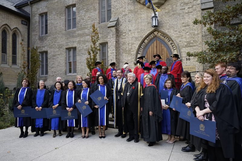 New Theology grad pose with the President and Chancellor