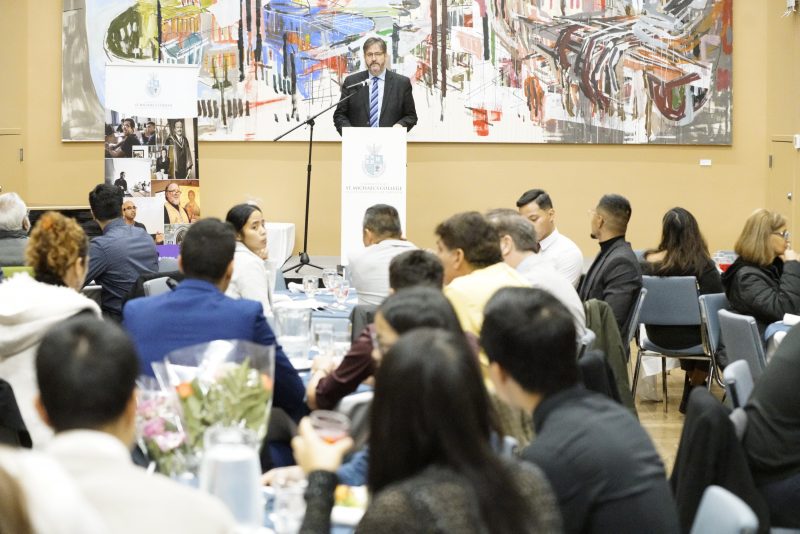 Image of Dr. David Sylvester talking to a group of students in Father Madden Hall