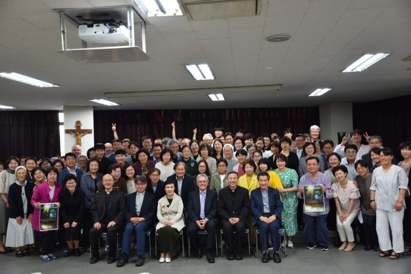 Image depicts Dr. Denis O'Hara with a group of people he met while traveling