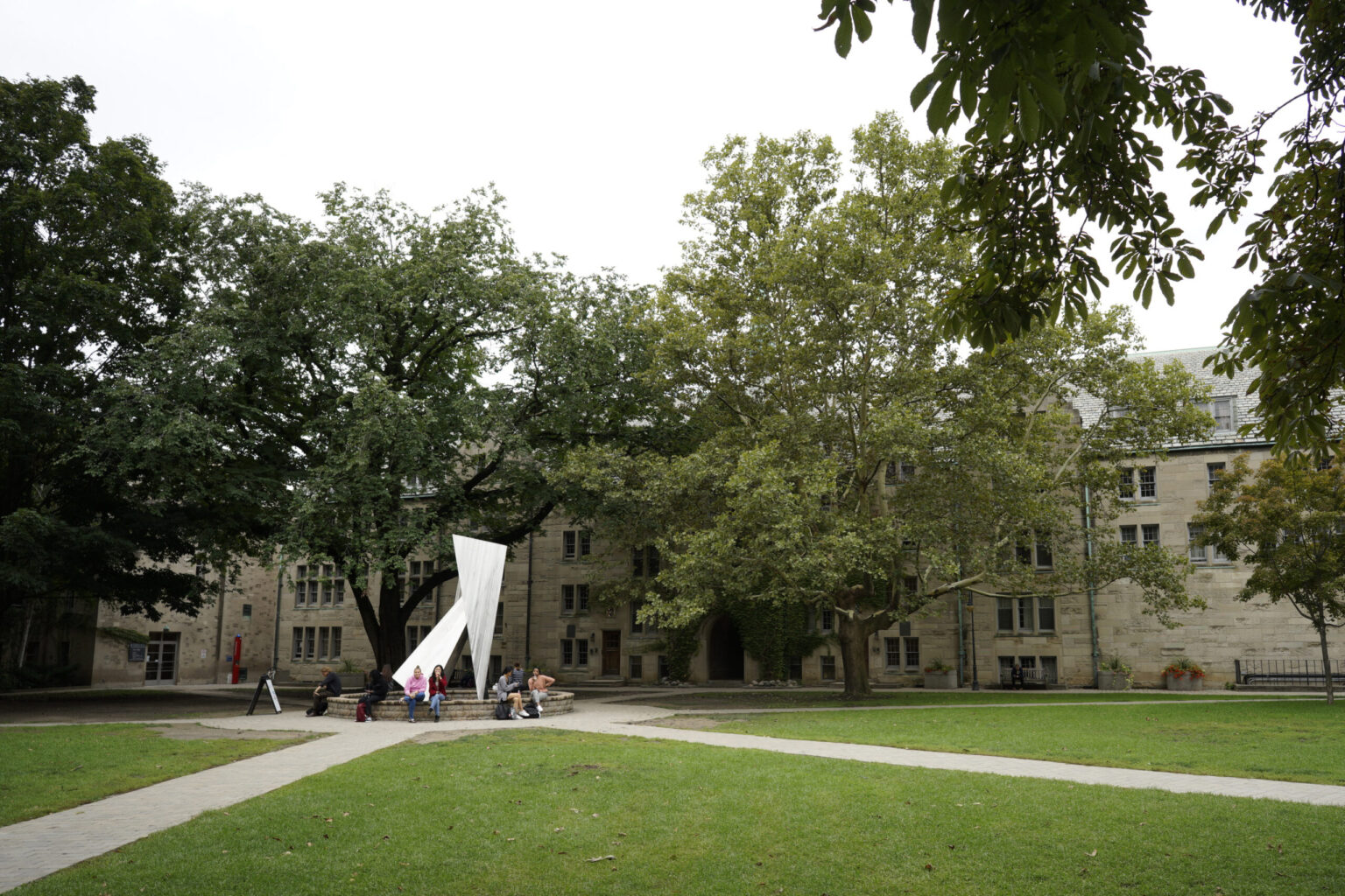 image depicts the St.Michael's college quad with the statute of St.Michael in the middle on an overcast day