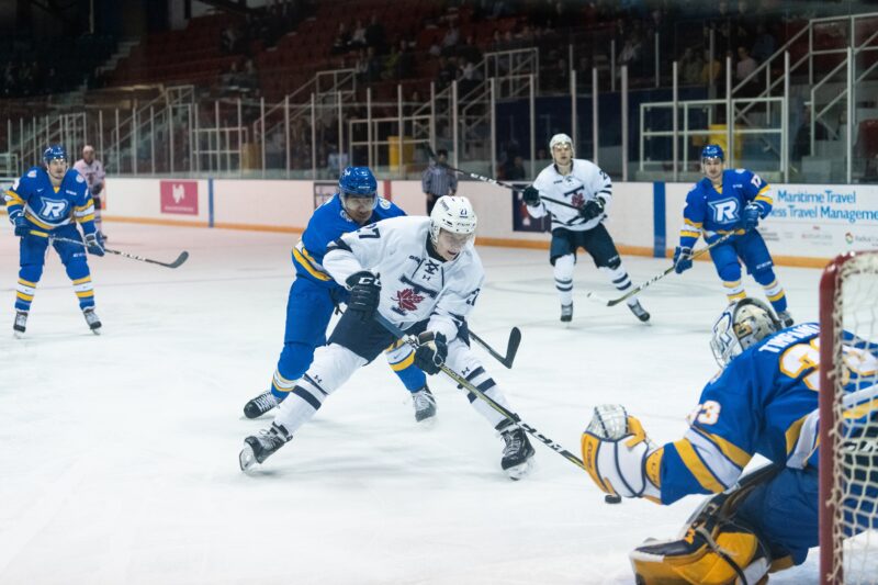 St. Michael's student athlete and Varsity Blues Men's Hockey forward Kyle Potts approaches the goal during a game against the Ryerson Rams. 