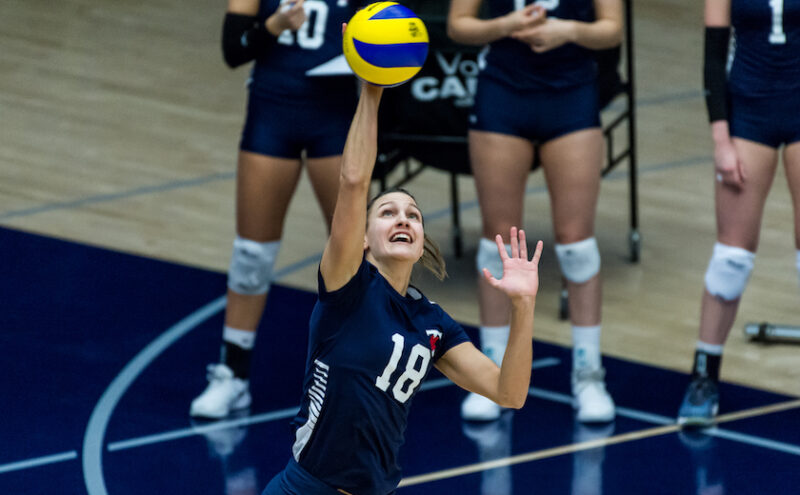 St. Michael's student athlete Anna Licht serves during a Varsity Blues volleyball match. 