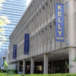 Image depicts the Kelly Library exterior in the spring time