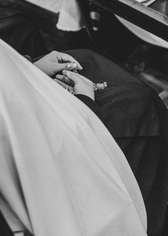 Black and white image of a nun holding a rosary