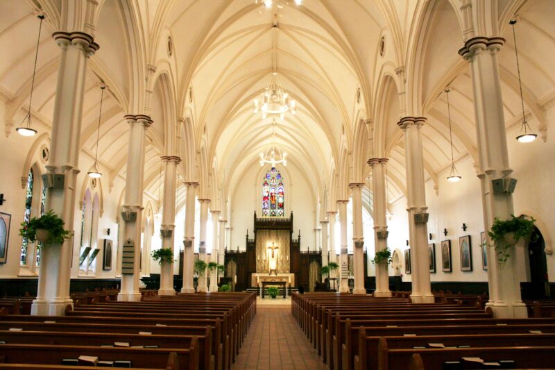 Image depicts the interior of St. Basil's Church facing the altar from the back. 