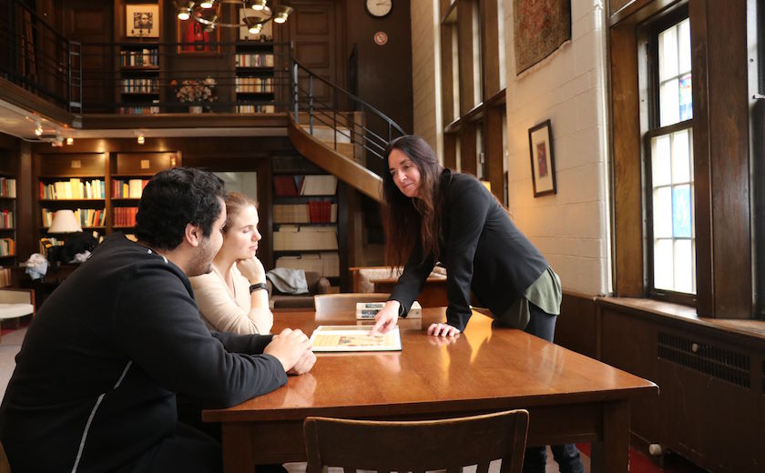 Image depicts St. Michael's prof Alison More teaching students in the Shook Common Room on the St. Michael's campus 