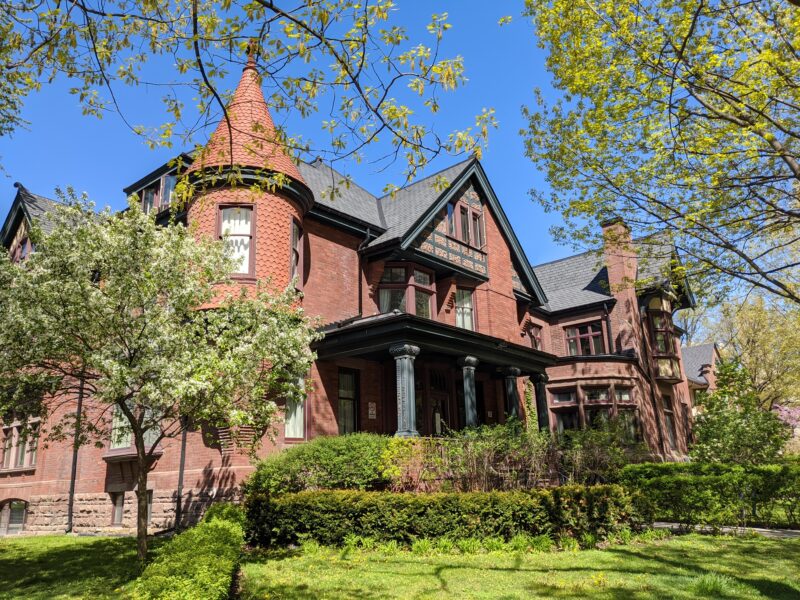 Image depicts two of the historic houses on the St. Michael's campus on a sunny summer's day seen from the southeast