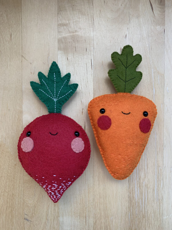 Photograph of hand-sewn radish and carrot plushies