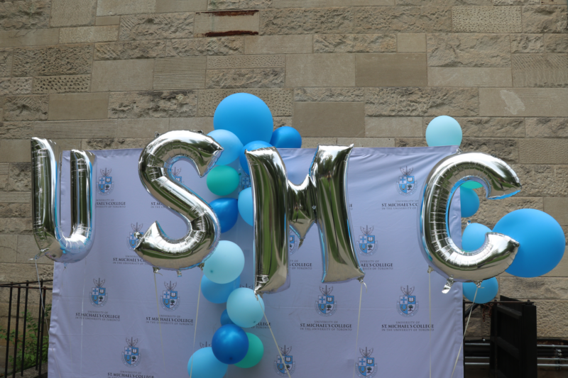Photograph of silver U S M C balloons with blue balloons in the background