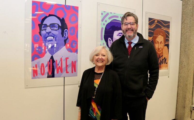 Karen Pascal, who is the Executive Director of the Toronto-based Henri Nouwen Society, stands next to a portrait of Henri Nouwen alongside St. Michael's President David Sylvester