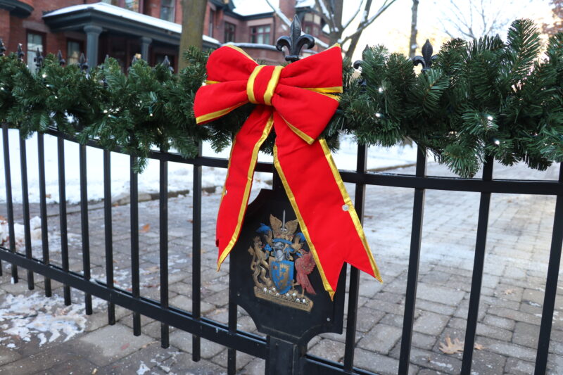 A bow tied around the wrought iron gate on Elmsley Place