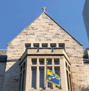 View of Brennan Hall's flag and pediment at St. Michael's College