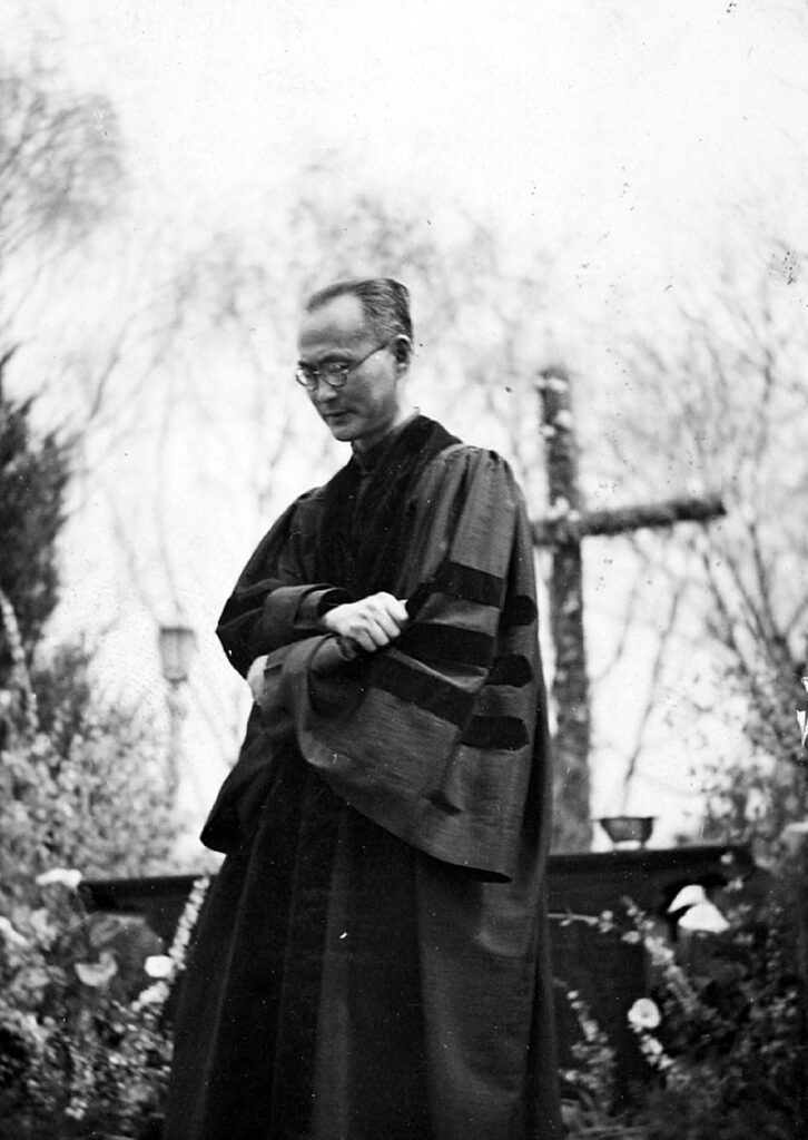 Black and white photograph of T.C. Chao in front of an outdoor altar