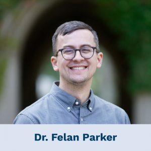 Headshot photograph of a smiling Dr. Felan Parker. The ivy-covered University of St. Michael's College Soldiers’ Memorial Slype is out of focus in the background.