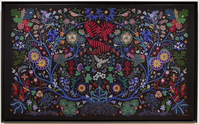 Photograph of a large painting of a floral woodland pattern with birds, achieved with many small dots to emulate beadwork.
