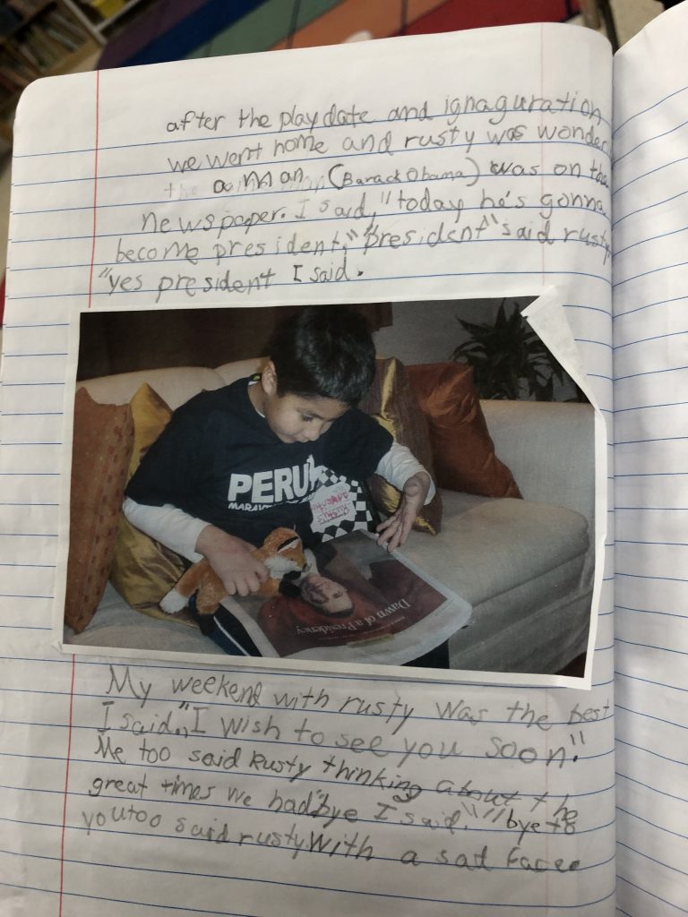 Photograph of a lined notebook with writing and a photograph of a young Nicolas Vergara Ruiz wearing a shirt that says "PERU" and holding a plush fox to a photograph of Barack Obama in a newspaper. 

The writing: "A man (Barack Obama) was on the newspaper. I said, 'today he's gonna become president.' 'President' said Rusty 'yes president' I said. 

"My weekend with Rusty was the best I said. 'I wish to see you soon.' Me to said Rusty thinking about the great times we had. 'Bye' I said. 'Bye to you too' said rusty with a sad face. 