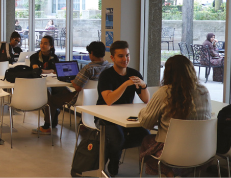 Students sit together at a table in the Coop on the St. Michael's campus 