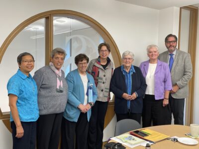 Dr. Koster (centre) and Dr. Syvester (far right) with the Sisters of St. Joseph Leadership Team members Sister Nida Fe Chavez, Sister Georgette Gregory, Sister Anne Purcell, Sister Anne Marie Marrin, and Sister Mary Anne McCarthy. 
