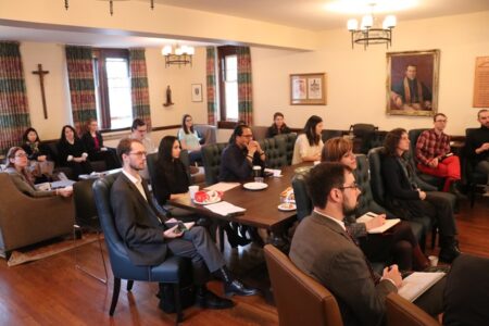 A seated audience in the Basilian Common Room during the 2018 student research colloquium 