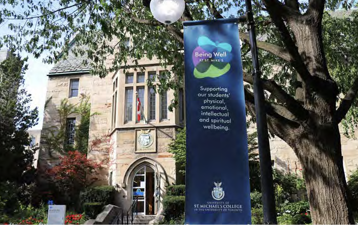 A view of the "Being Well at St. Mike's" 
 banner in front of Brennan Hall