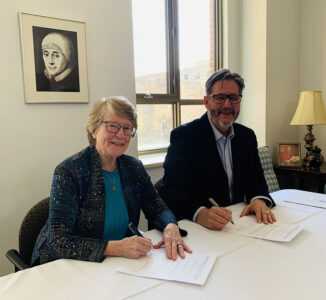 Sr. Jane McDonell and David Sylvester sign the agreement between USMC and IBMV. 