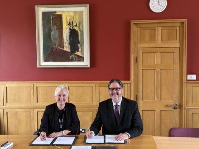 Rachel Msetfi, Vice President Research and Innovation, Maynooth University signing an Mou with David Sylvester, President of the University of St. Michael's College
