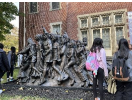 Students exploring Art, Theology and Social Justice through the various sculptures on campus.