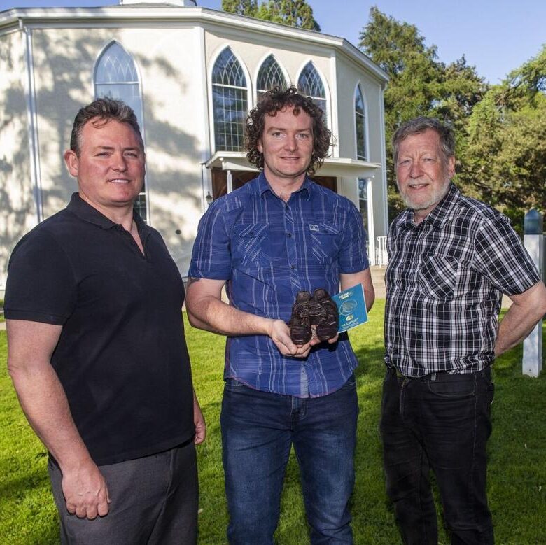 From left: Declan O’Sullivan, president of Irish Music Niagara; Patrick Treacy, chair of Irish Music Niagara; and Mark McGowan, professor of history at University of St. Michael’s College in the University of Toronto, with a pair of bronze shoes that will be on display in Niagara to memorialize Irish immigrants who fled the potato famine of the 1840s and ended up in countries around the world. Bob Tymczyszyn St. Catharines Standard