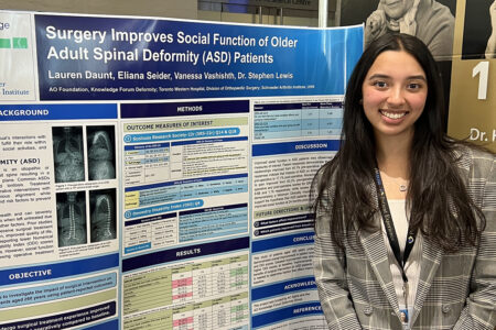 Lauren Daunt in front of a poster explaining research project she was a part of.