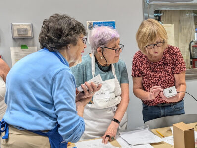 Book sale volunteers learn how to cash out sales