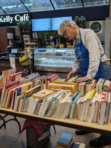 A volunteer sorts books at the Kelly Library book sale