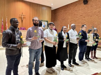 Regis St. Michael's graduands receive a rose and prayer during the commissioning Mass
