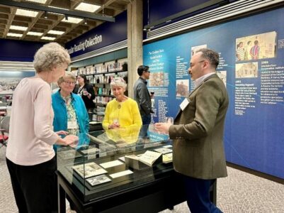 Guests of the reception to celebrate the Catholic Religious Communities Archives (CRCA) research initiative view the current exhibit in the Kelly Library,