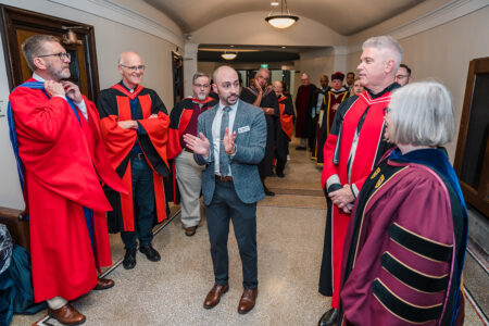 Newly named Chief of Staff Greg Rupik gives instructions before academic procession